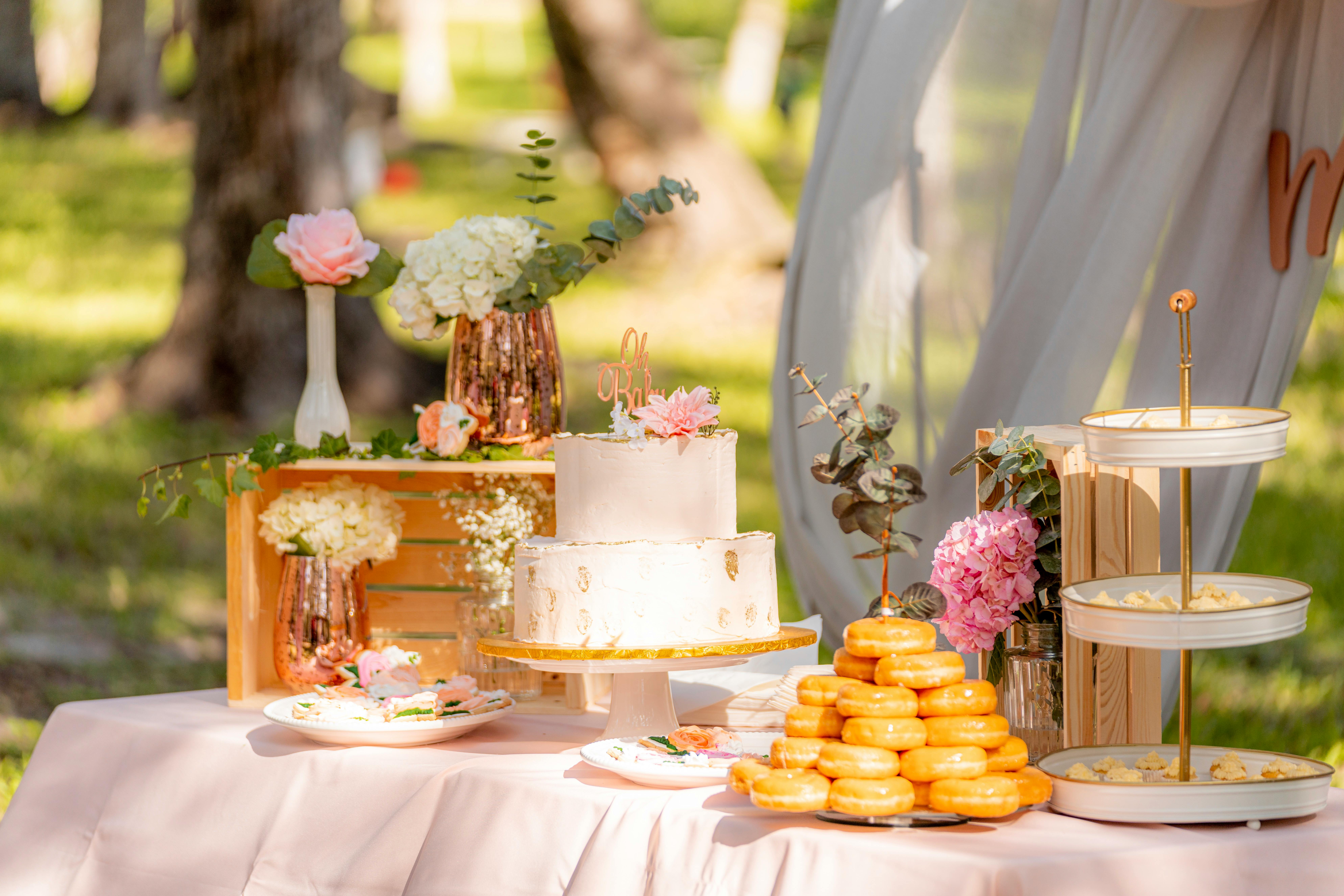 outside table with cake and flowers